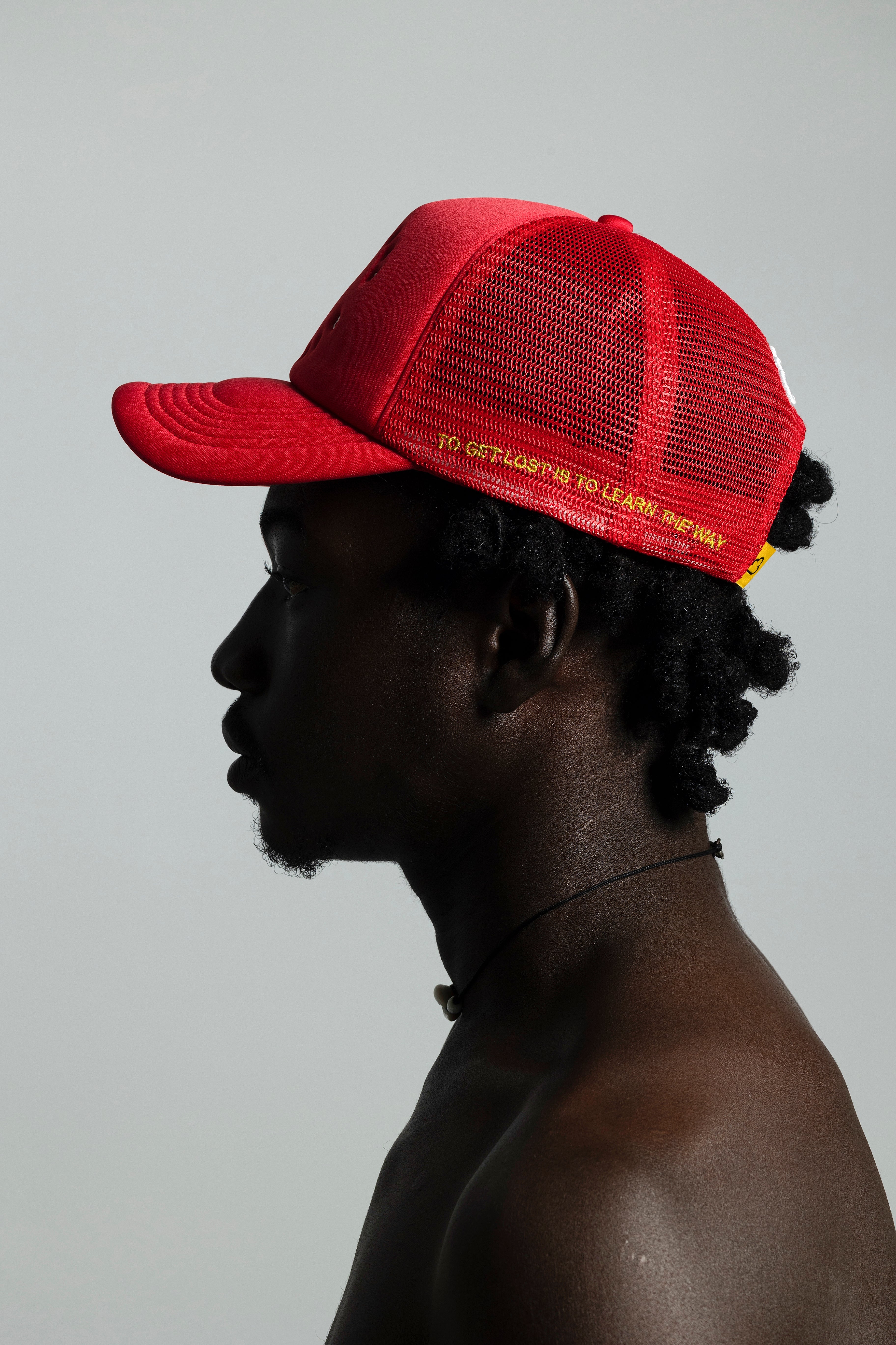 African Proverb Circle Logo Trucker Hat